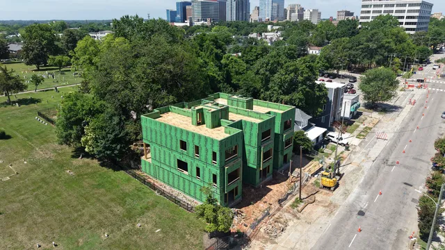 Building under construction with neighborhood context